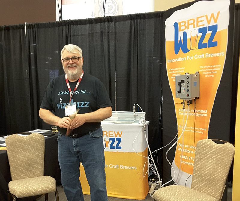 Cyril Meagher standing in the BrewWizz booth at a trade show